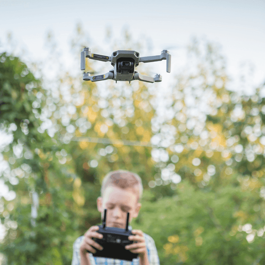 kid flying a drone