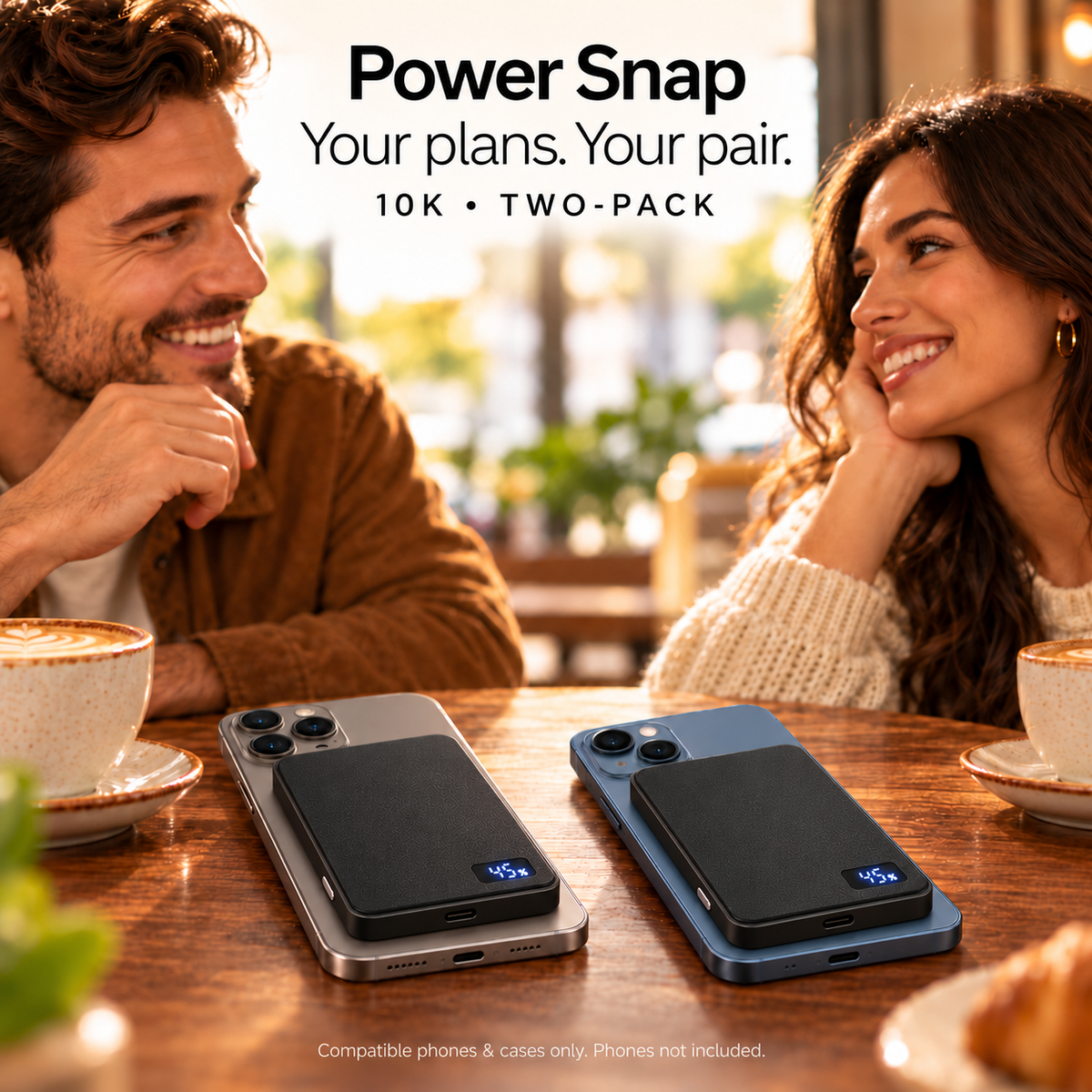 Two Power Snap 10K banks with compatible phones at a cafe, digital displays showing charge percentage. Phones and props not included.