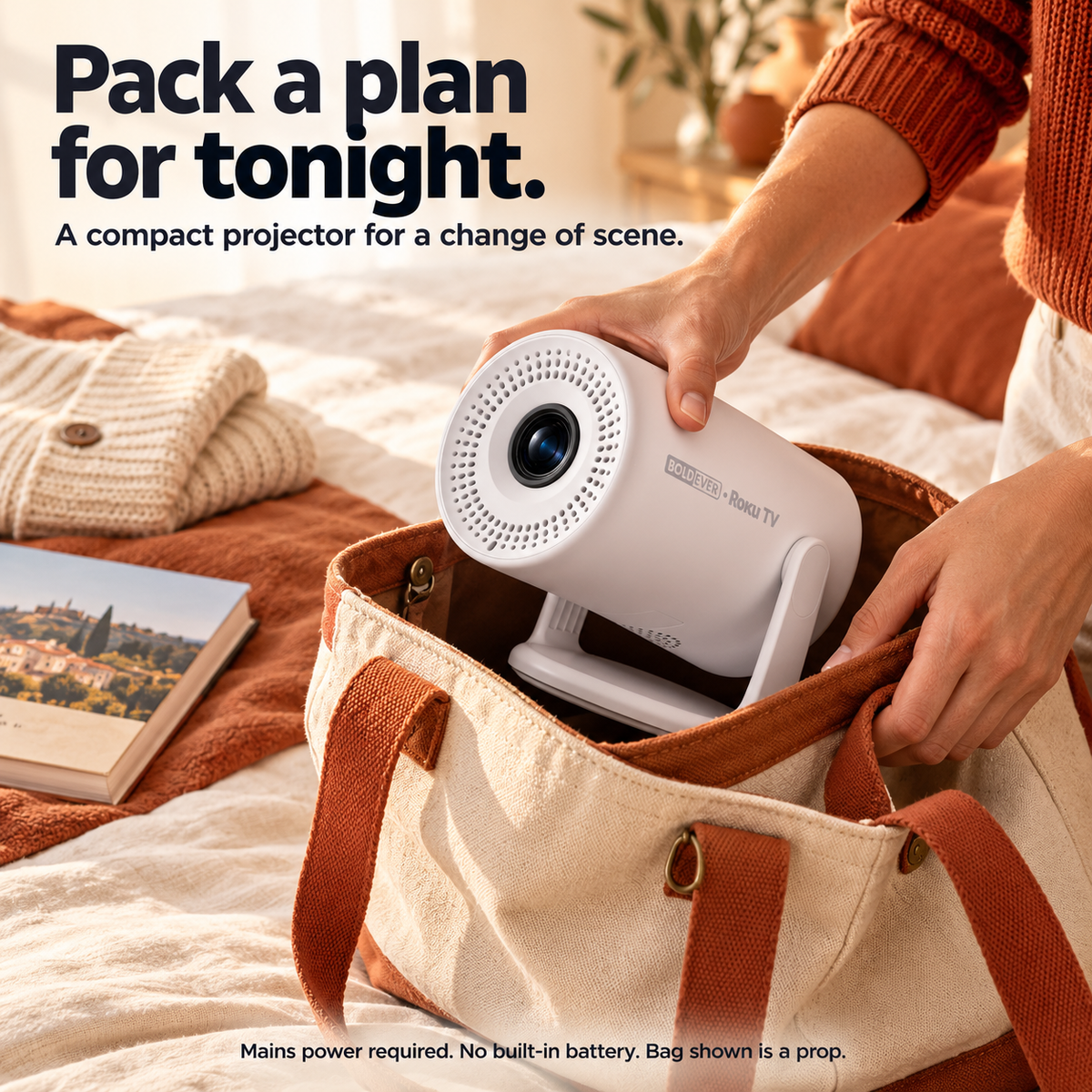 Hands place the powered-off compact projector into a weekend bag.