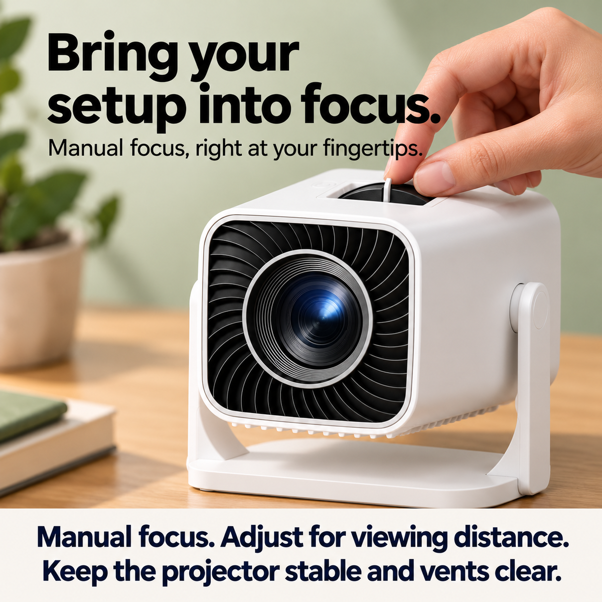 A hand adjusts the recessed manual-focus tab on the full, source-faithful rounded rectangular projector with stand.