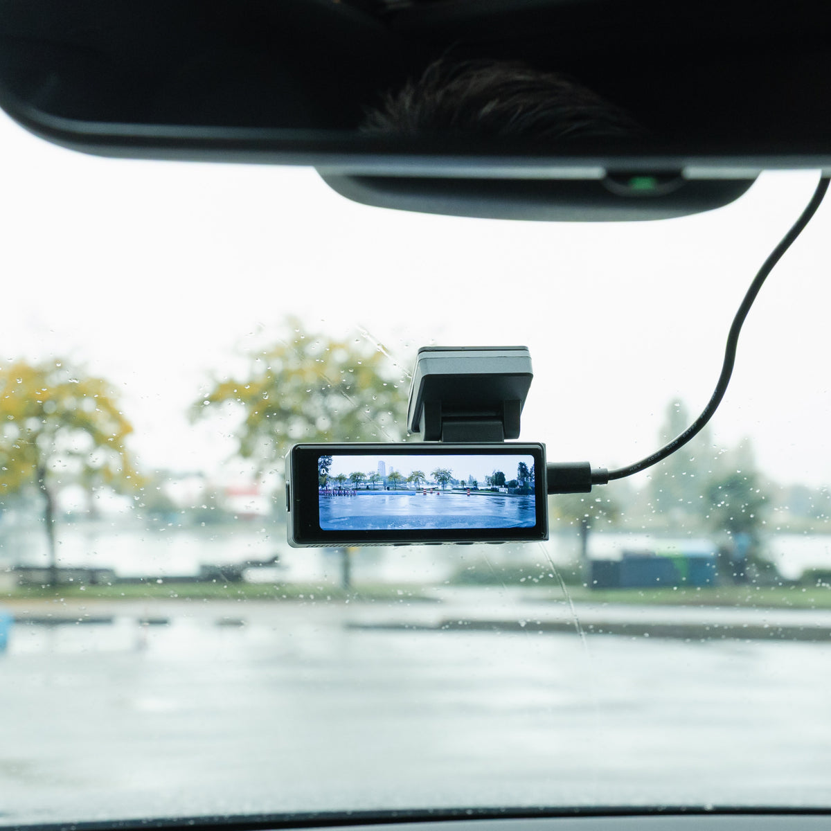 Road Guardian 2 dash cam mounted behind the rear-view mirror in a car